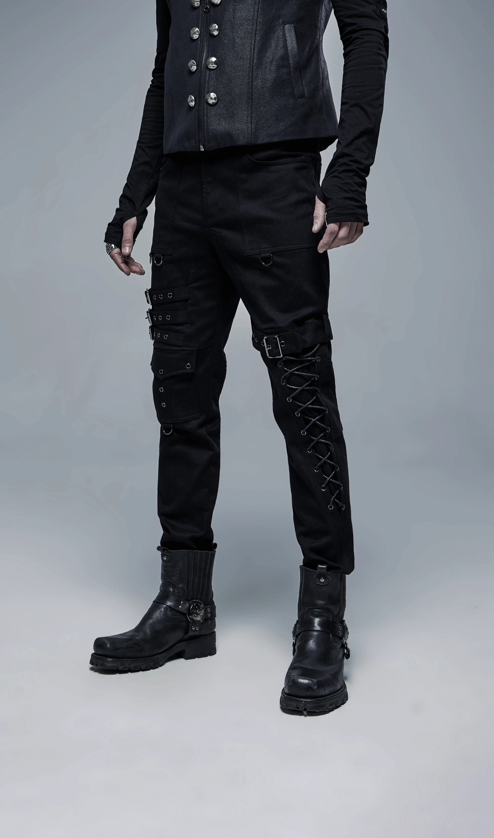 Black gothic cargo pants worn by model showing overall aesthetic styling with buckle and lace-up details
