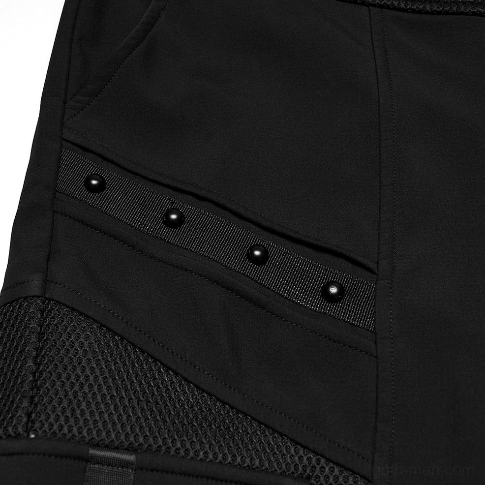 Close-up texture detail of black gothic cargo pants metal snap buttons and mixed woven mesh fabric matte finish