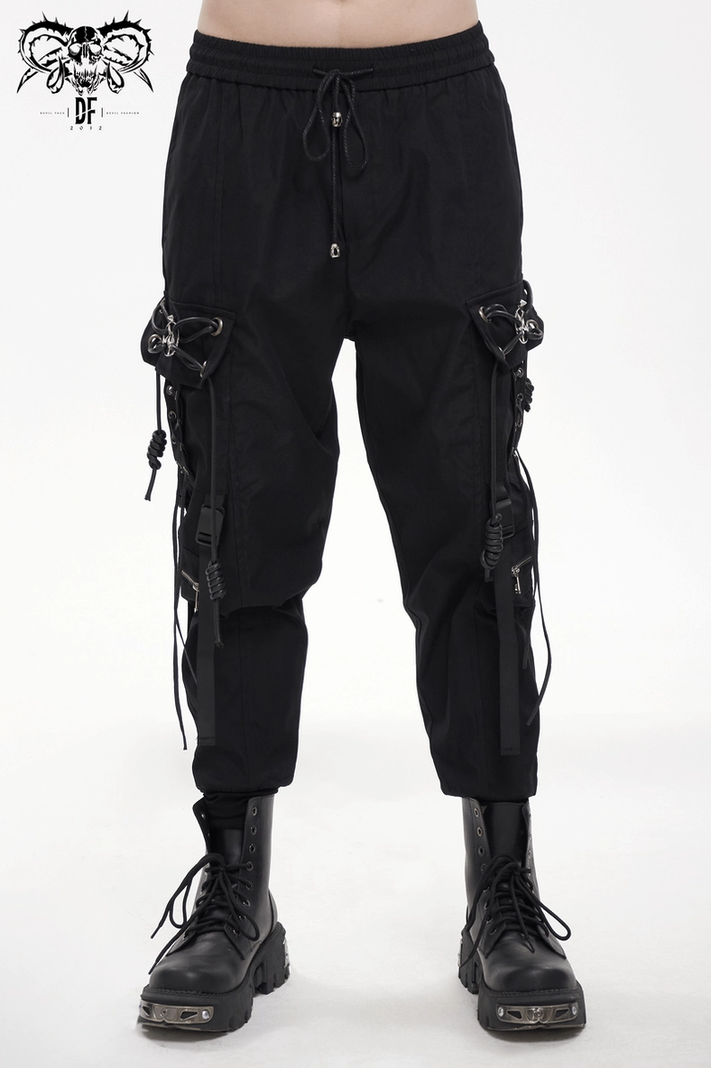 Black gothic cargo pants full front view on male model showcasing pentagram hardware and tactical utility aesthetic