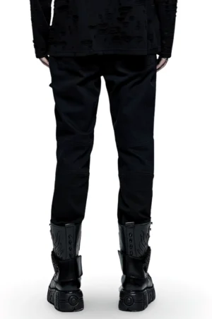 Rear view of black gothic punk cargo pants on male model with platform boots showcasing minimalist back design