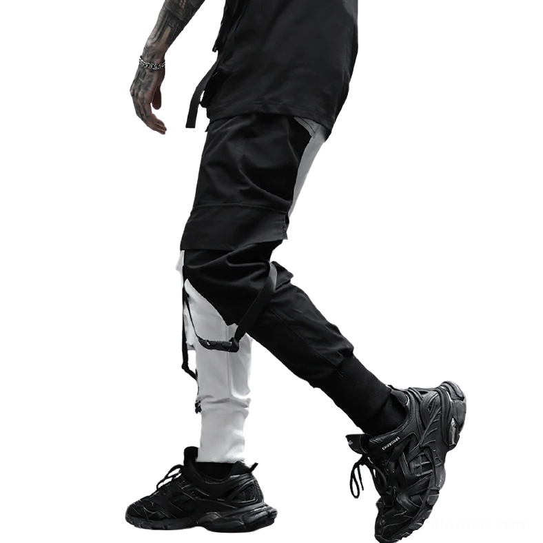 Side and back view of color-block cargo pants showing split black and white color scheme and ankle straps