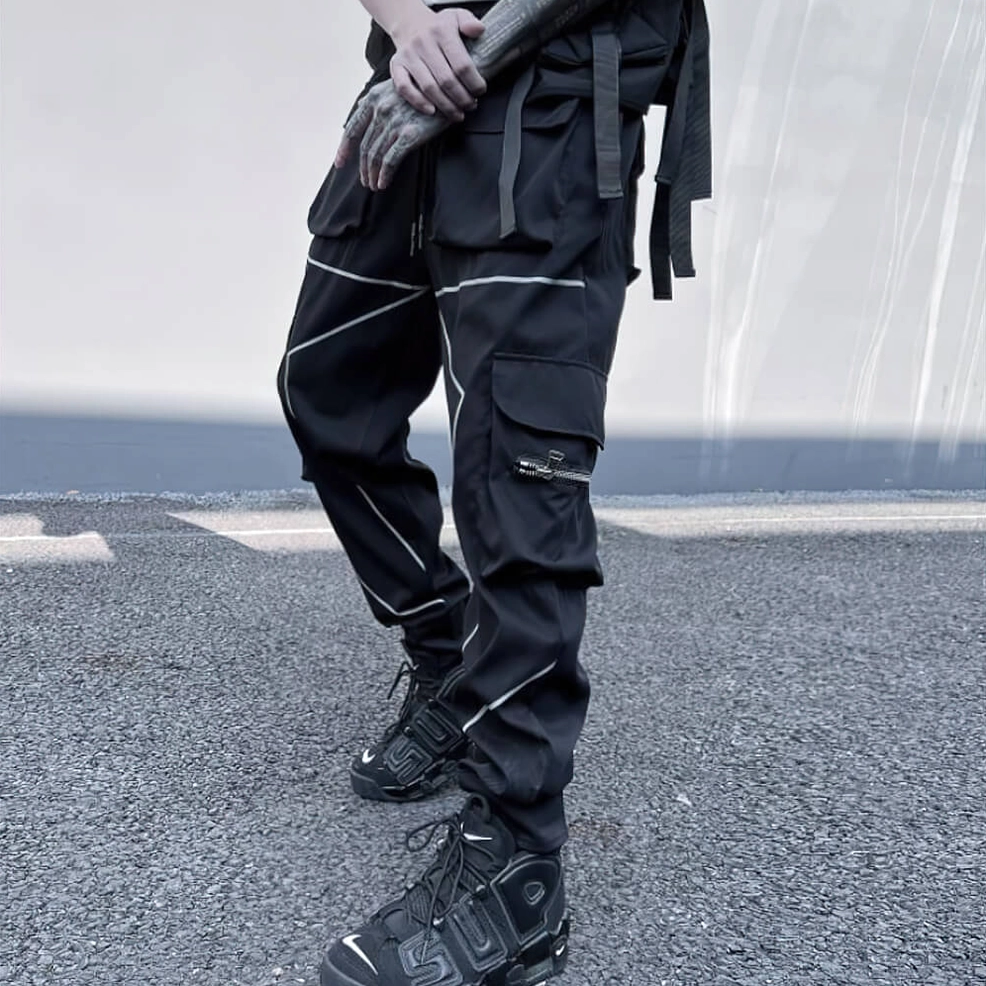 Black cargo pants street style side view showing reflective piping and cargo pocket system