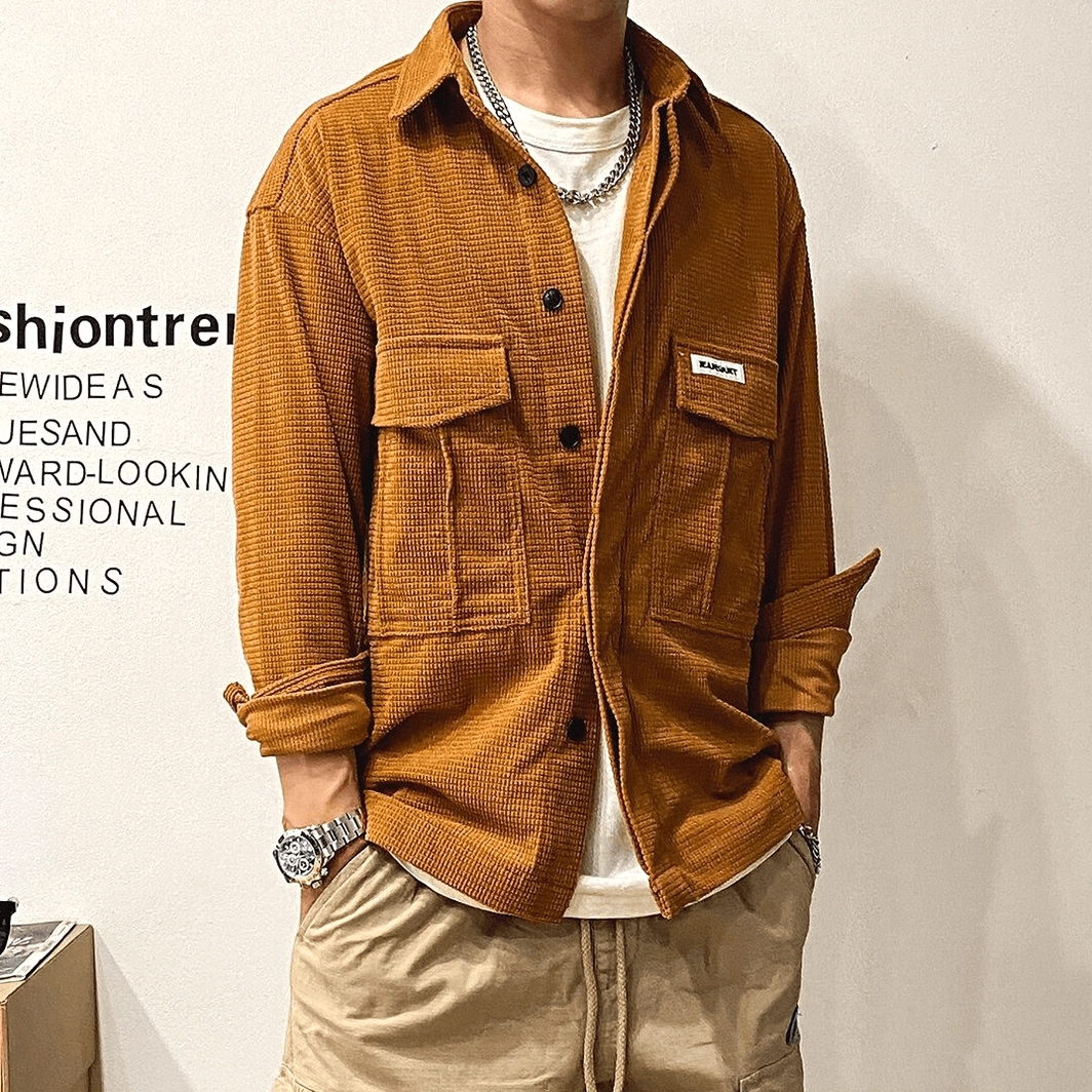 Oversized gothic cargo shirt detail emphasizing large flap pocket design, button closure system, and structured cargo pocket construction for functional style