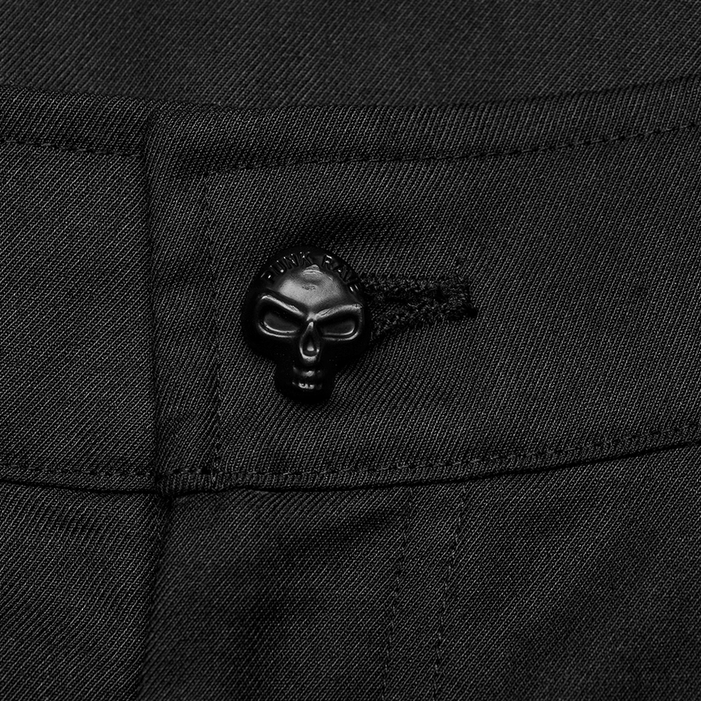 Close-up detail of skull-shaped decorative button on waist of black gothic cargo trousers, twill fabric texture