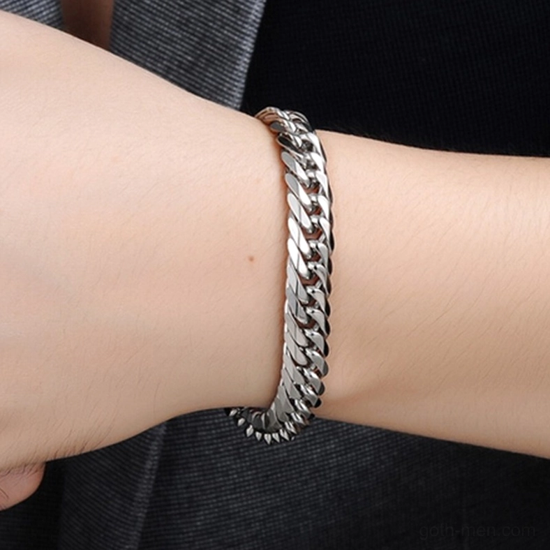 Male wrist wearing polished silver stainless steel gothic curb chain bracelet lifestyle shot