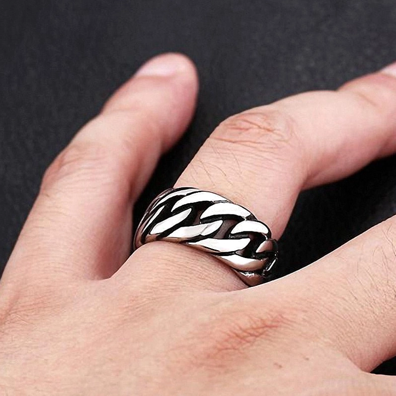 Matte gunmetal gothic chain ring on smooth black leather displaying industrial aesthetic