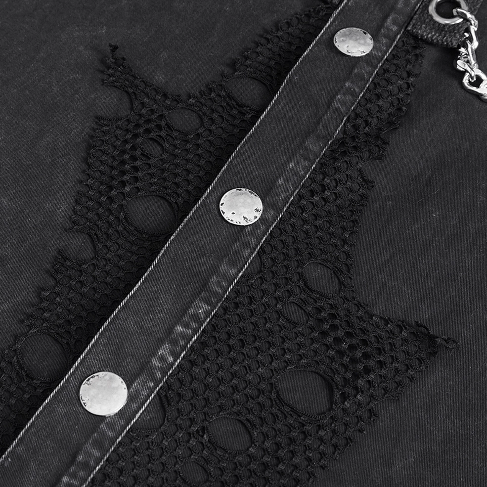 Detailed close-up of gothic chain vest snap buttons and distressed mesh fabric construction