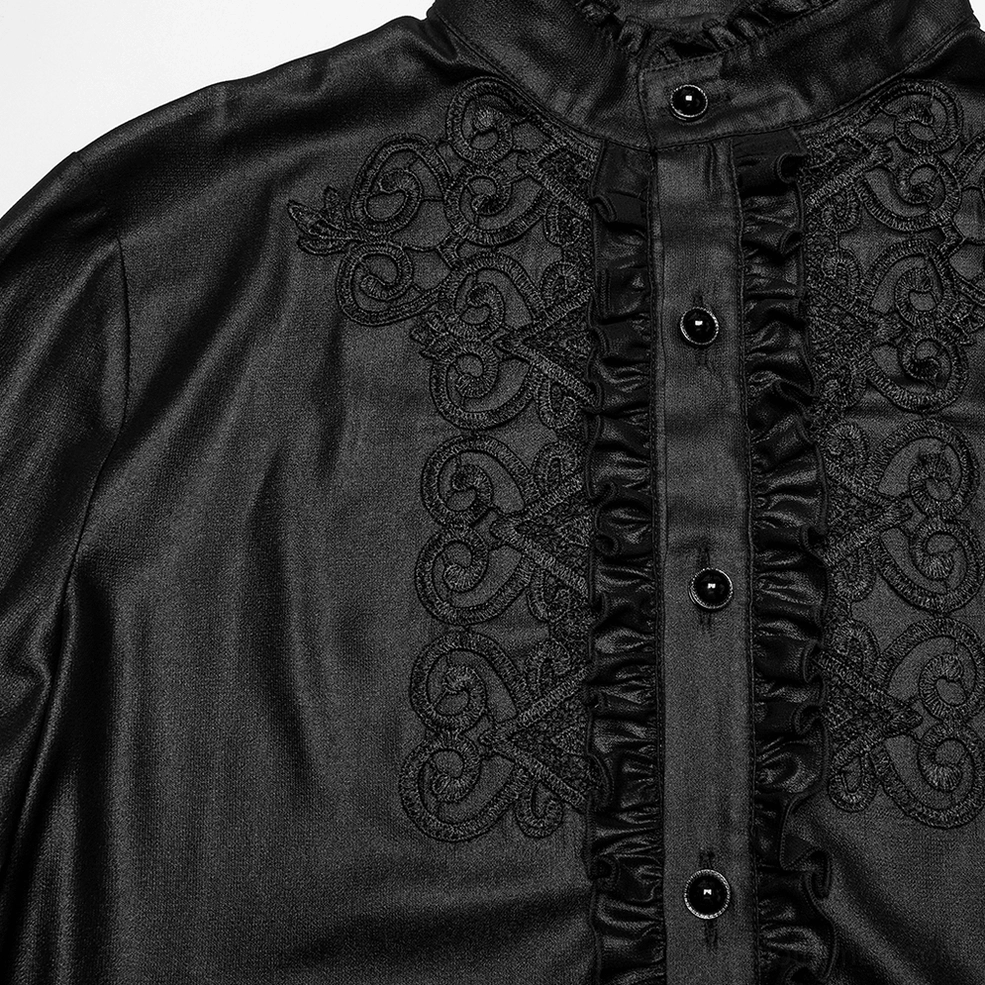Detailed close-up of scroll lace embroidery and ruffled placket trim with black round buttons on gothic shirt