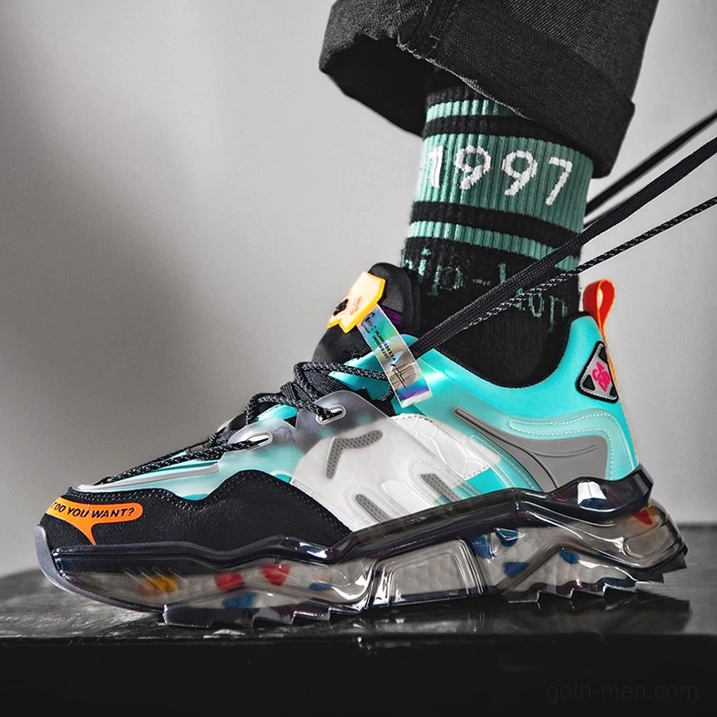 Worn gothic chunky sneakers on male model showing street styling with crew socks and transparent colorful outsole during wear