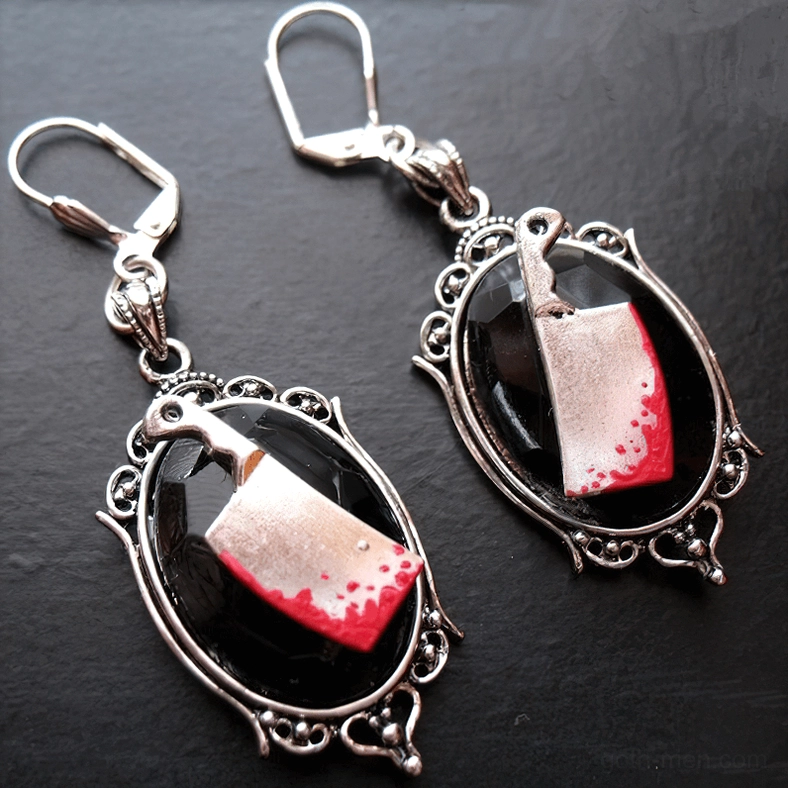 Asymmetric vintage carved metal frame gothic cleaver earrings with black resin gem, side angled view