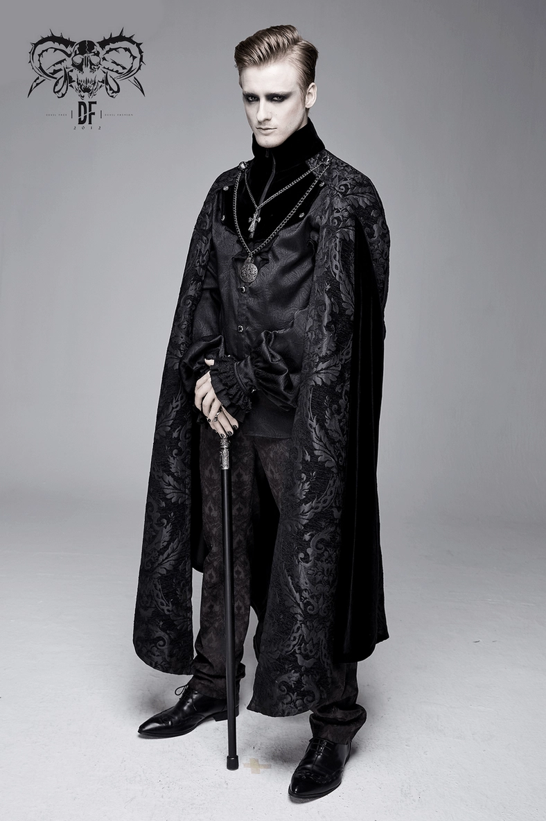 Full-body styling view of men's gothic black cloak with stand-up collar, damask details, and silver cross pendant accent