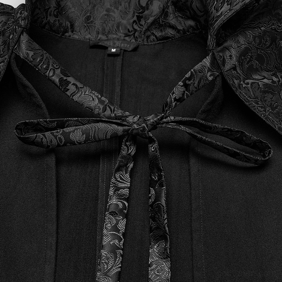 Gothic cloak neck fastening close-up - jacquard woven tie ribbon and embroidered collar trim detail