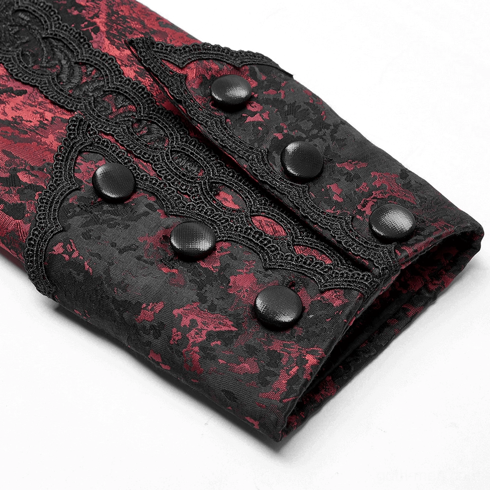 Close-up top-down view of wine red gothic coat cuff with decorative lace edging and black buttons