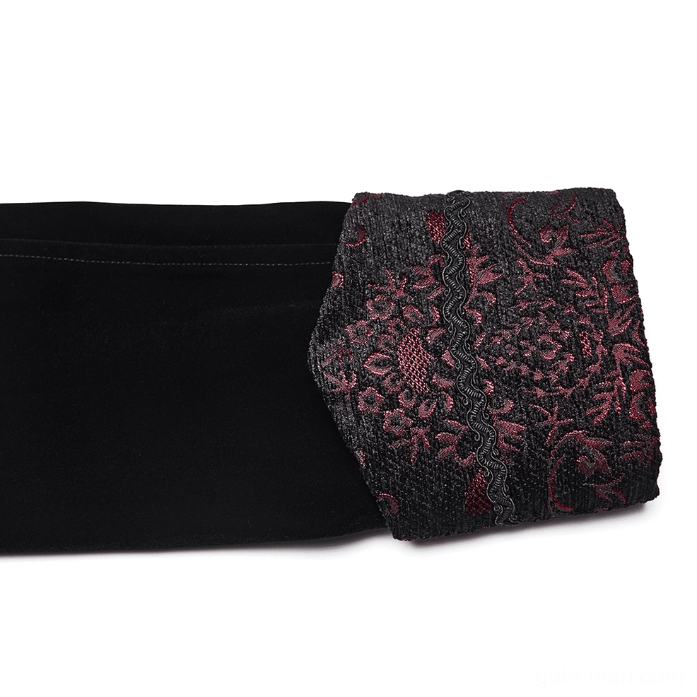 Close-up detail of velvet coat cuff showing red floral embroidery on black material