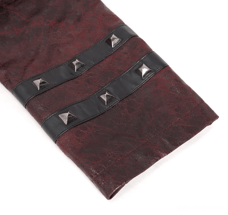Close-up detail of pyramid metal studs on black leather cuff straps of gothic trench coat