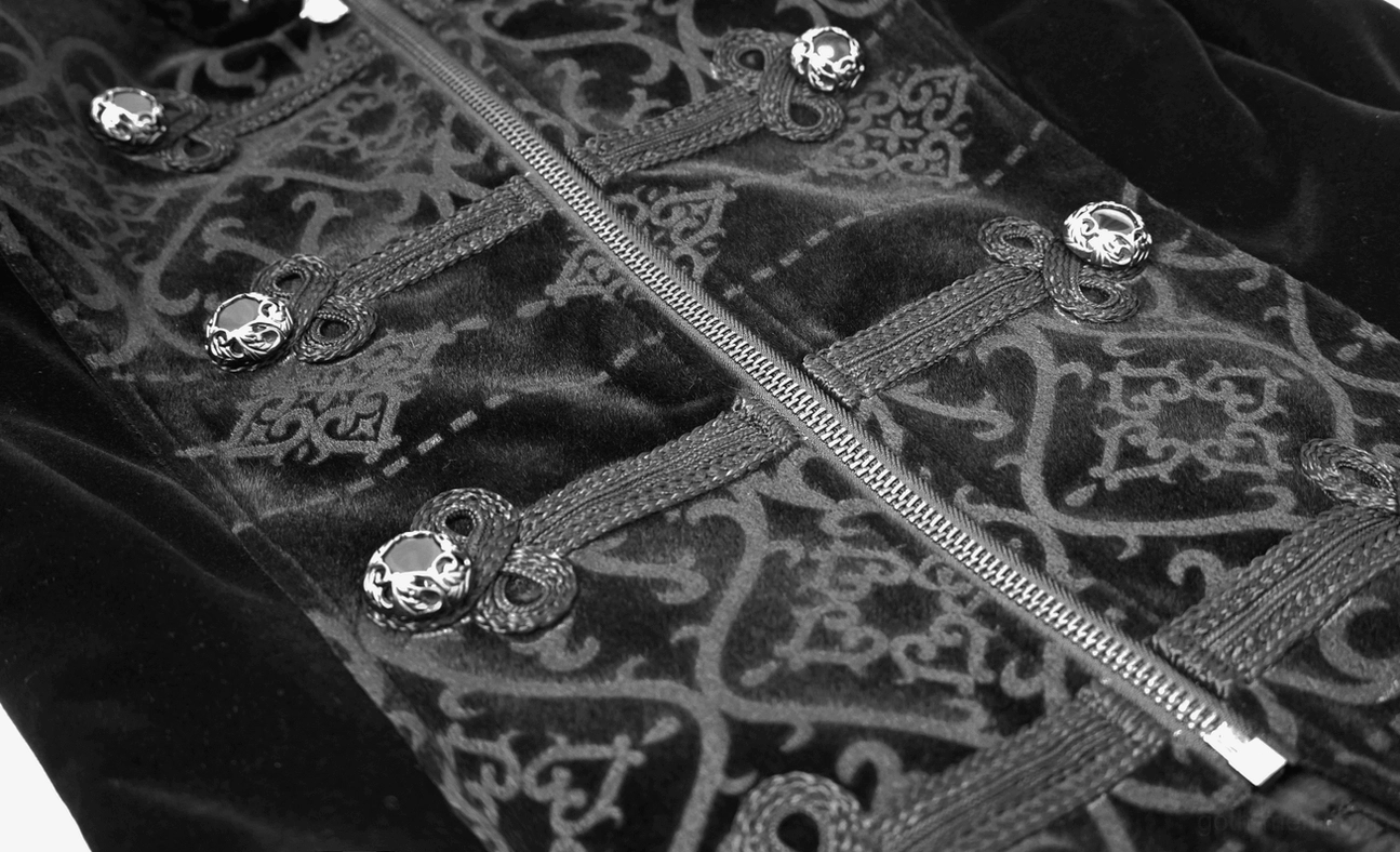 Close-up of black gothic velvet coat front zipper and engraved silver button detail on embossed fabric