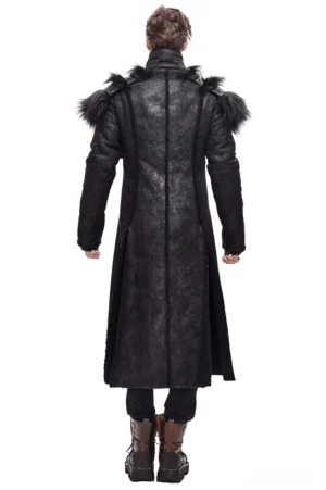 Rear view of black gothic long coat on model, displaying tailored back panel, split hem design, and removable fur shoulder pads