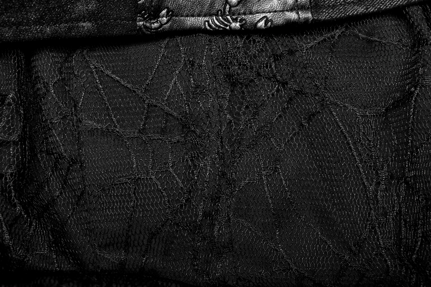 Gothic coat side seam and hem split detail showing asymmetrical design elements