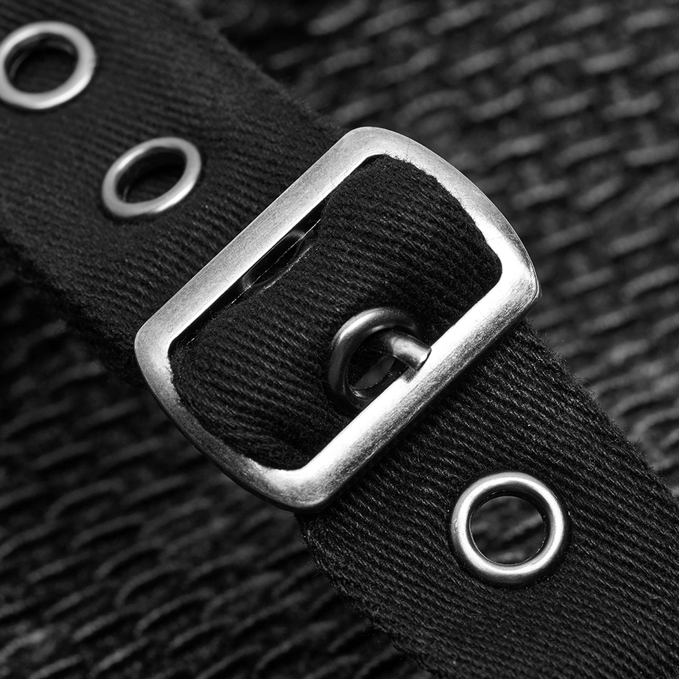 Macro close-up of stitched leather accents and black metal studs on gothic hooded coat construction