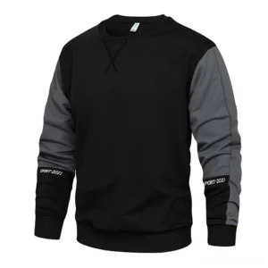 Men's gothic colorblock crewneck sweatshirt with black and dark gray two-tone design, front three-quarter view showing embroidered cuffs and X-stitched crew neck detail