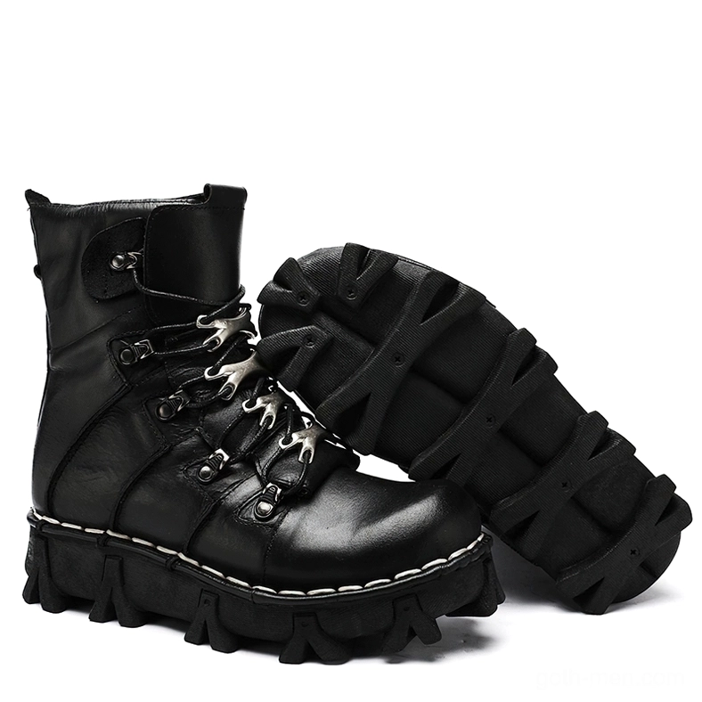 Pair of black leather gothic combat ankle boots flat lay display showing contrast stitching and aggressive lug pattern rubber sole