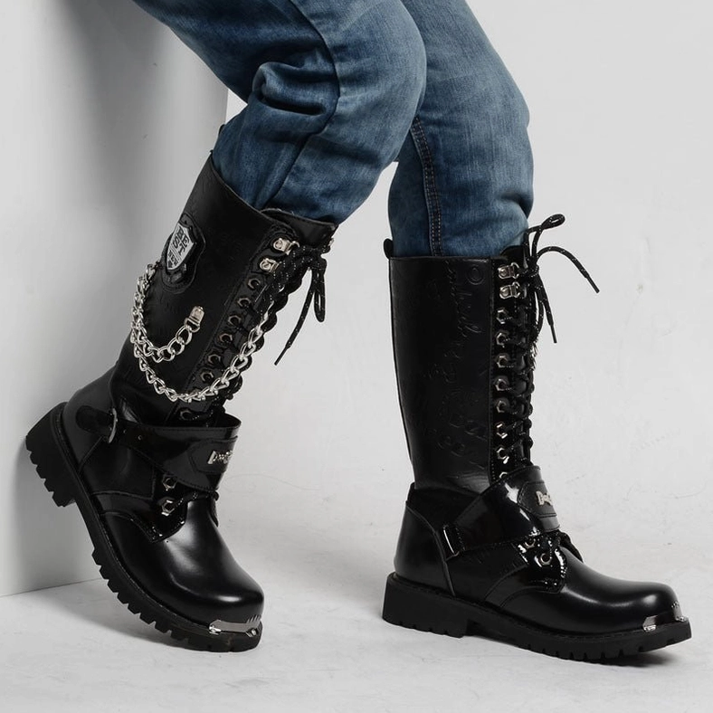 Model wearing handmade gothic combat boots with lace-up closure and metal chain accents, styled with blue jeans and side profile angle