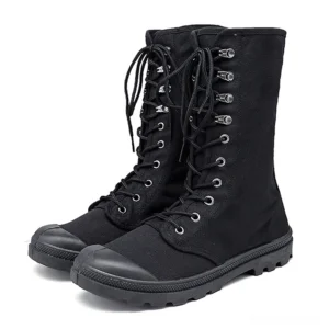Pair of black and green gothic lace-up combat boots mid-calf front view studio