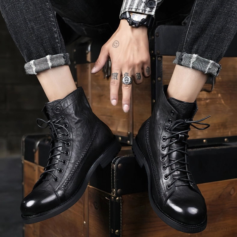 Men styling black gothic lace-up combat boots with vintage accessories indoors