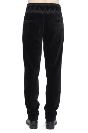 Black gothic corduroy pants rear view showing lace waistband trim and back welt pocket detail