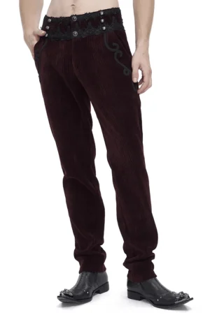 Wine red corduroy gothic trousers with black lace waist trim worn by male model, side front view showing fitted silhouette