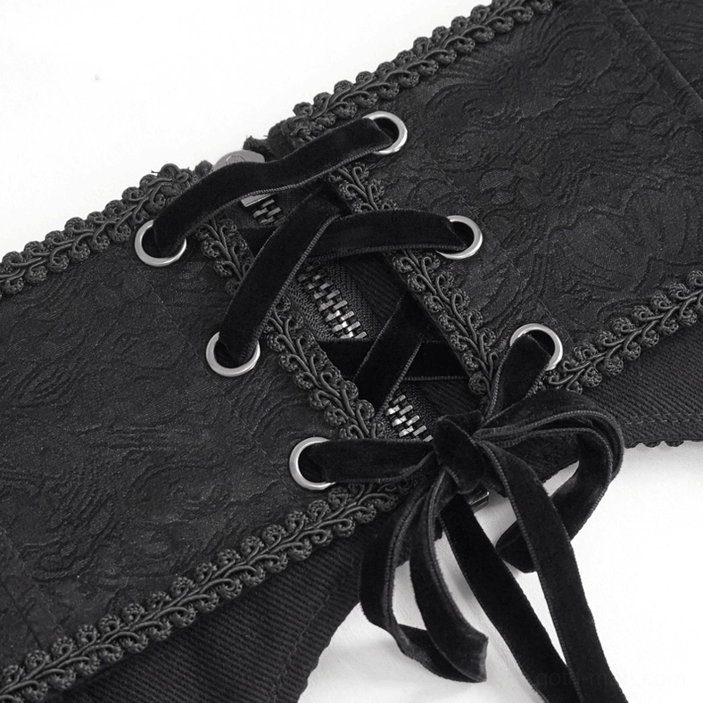 Detail view of black gothic corset belt showing embroidered trim, metal chains, and construction