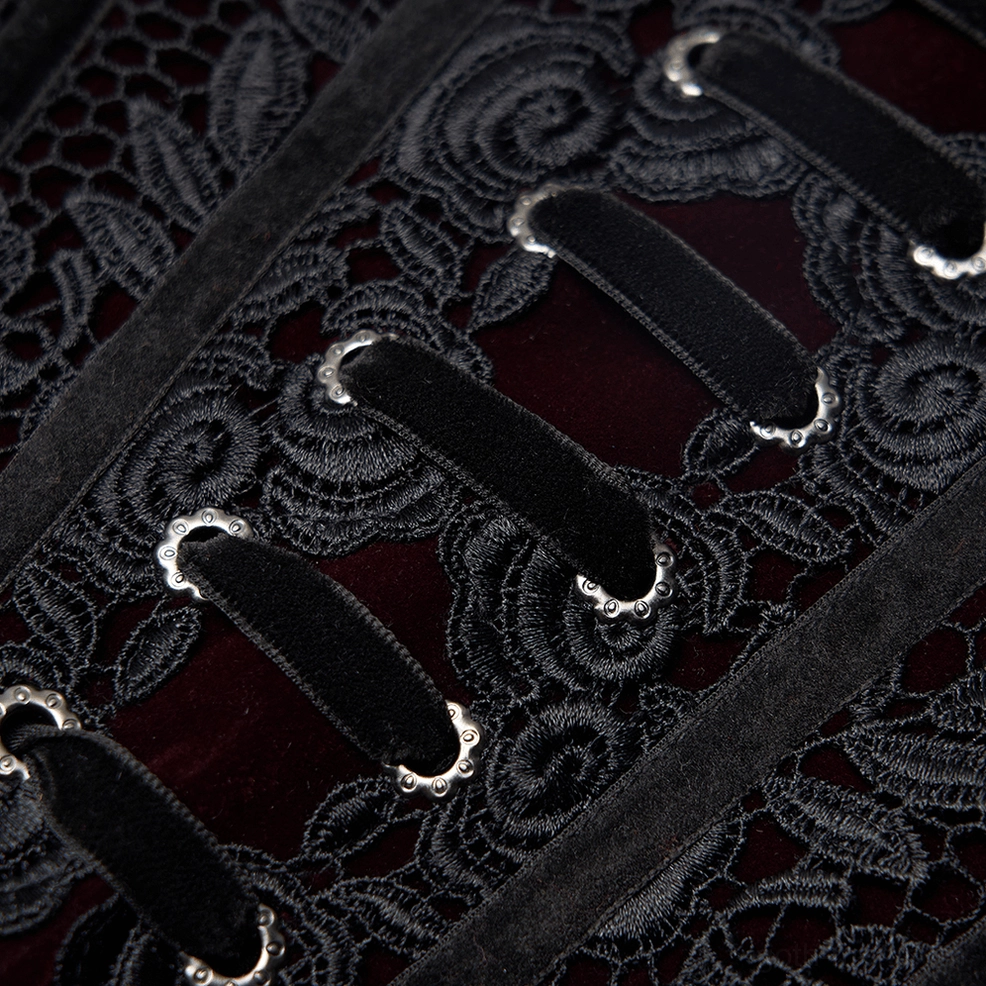 Extreme close-up of black floral lace embroidery and velvet trim detail on gothic corset belt