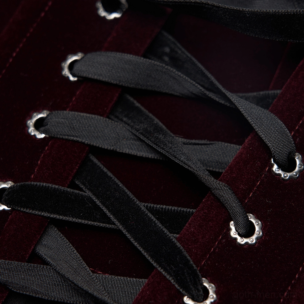 Close-up of burgundy velvet fabric and black lace ribbon front lacing with metal eyelets on gothic corset