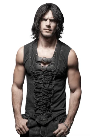Black gothic lace-up corset vest front view on male model, featuring dual antique brass buckle straps and full braided lace-up closure with metal eyelets