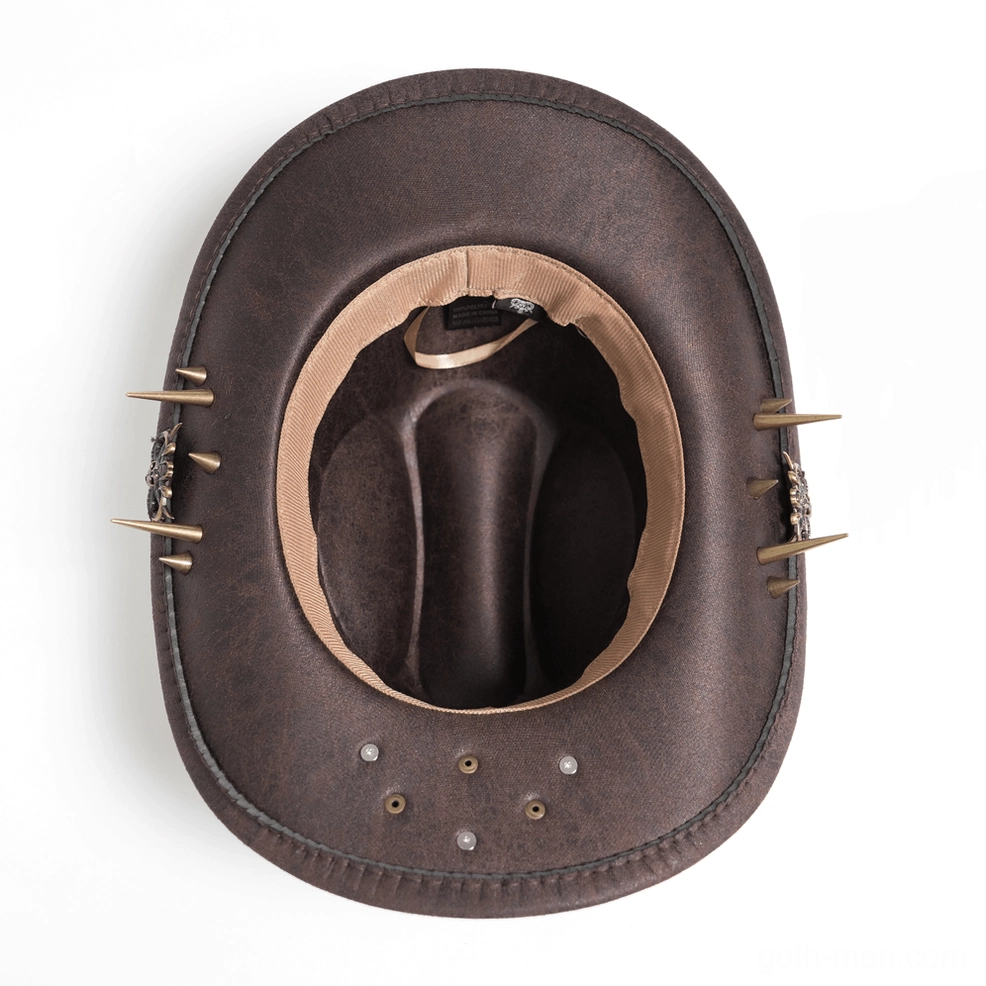 Steampunk western hat detail shot - close-up of metallic spike and resin bullet band decorations on brown synthetic leather