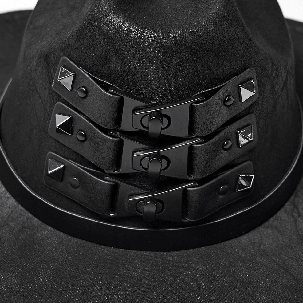 Close-up macro view of triple buckle hardware and pyramid studs on leather straps