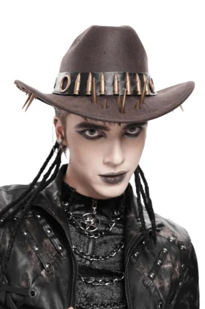 Brown gothic cowboy hat with metal bullet band and spike studs, worn by male goth model with braided hair, front close-up view showing punk metal hardware details
