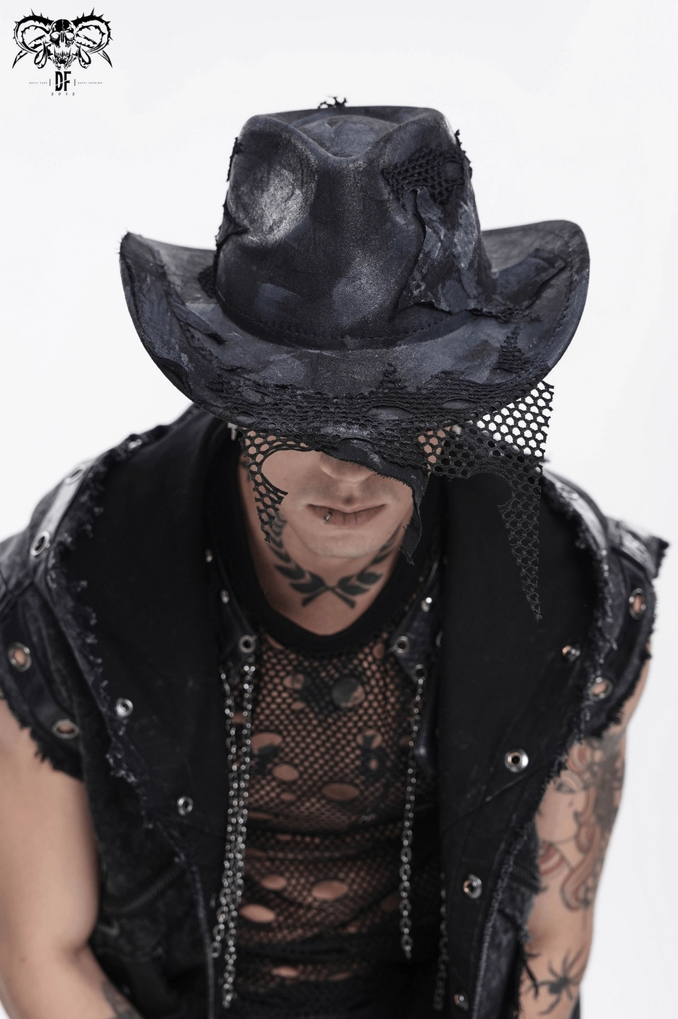 Gothic cowboy hat worn by alternative fashion male model demonstrating styling with dark aesthetic elements