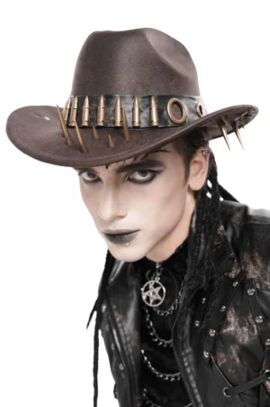 Three-quarter side angle of brown gothic cowboy hat with metallic bullet crown trim and spike brim, modeled by alternative fashion male in dark styling