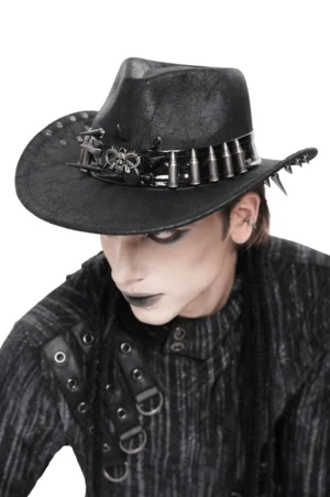 Dark gothic cowboy hat featuring metal skull and bullet accents worn by alternative styled male model, side three-quarter view