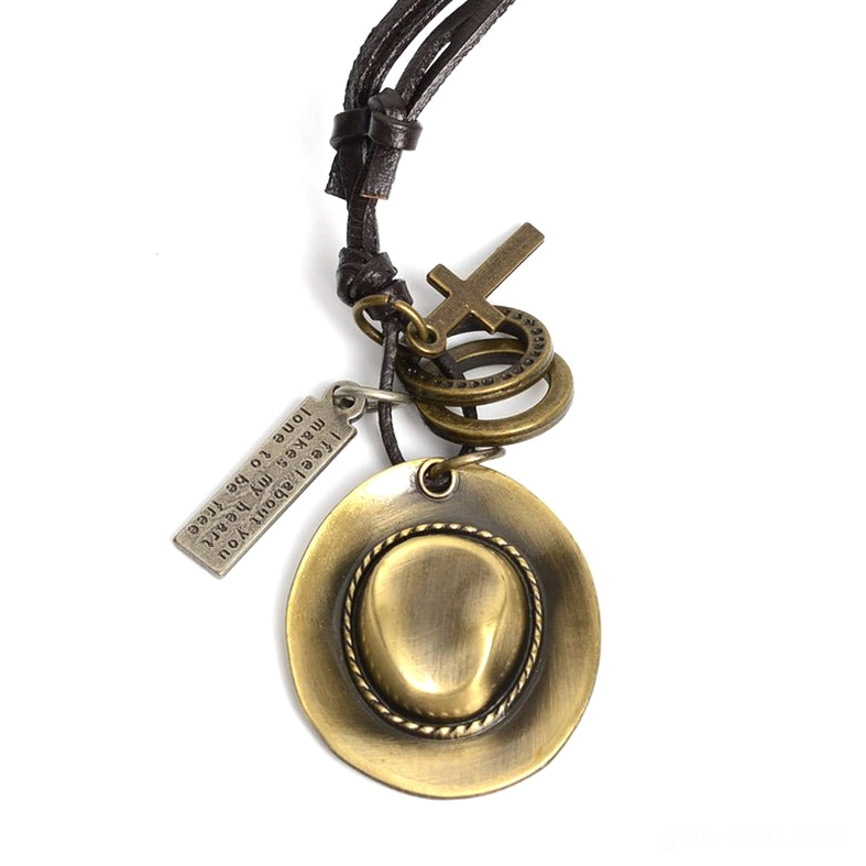 Gothic cowboy hat pendant necklace with cross and ring charms, bronze antique finish on leather rope chain, flat lay display