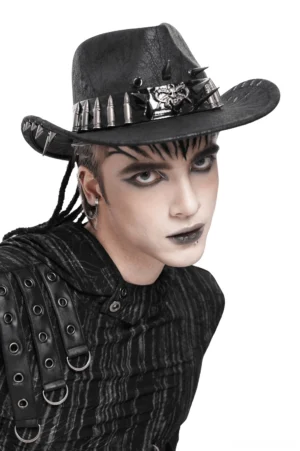 Black gothic cowboy hat with metal skull centerpiece and bullet band worn by male model with goth styling, front three-quarter view