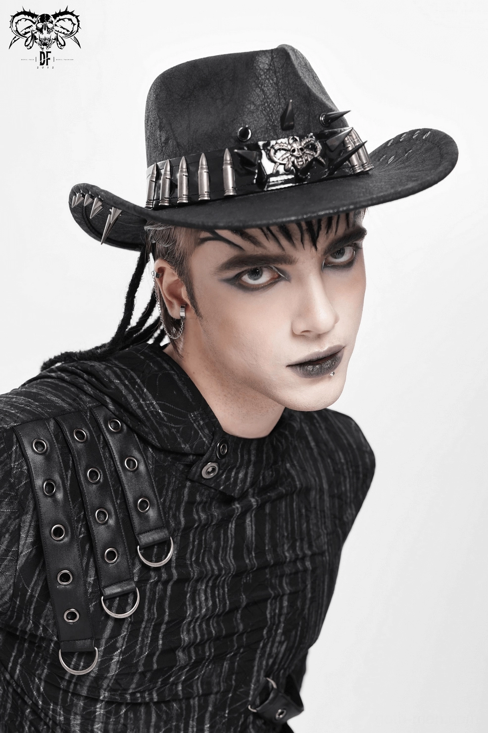 Black gothic cowboy hat three-quarter angle view showing metal spike bullet trim and faux leather construction