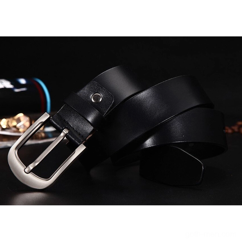 Black authentic cowhide belt with simple silver metal buckle design, flat lay on dark background