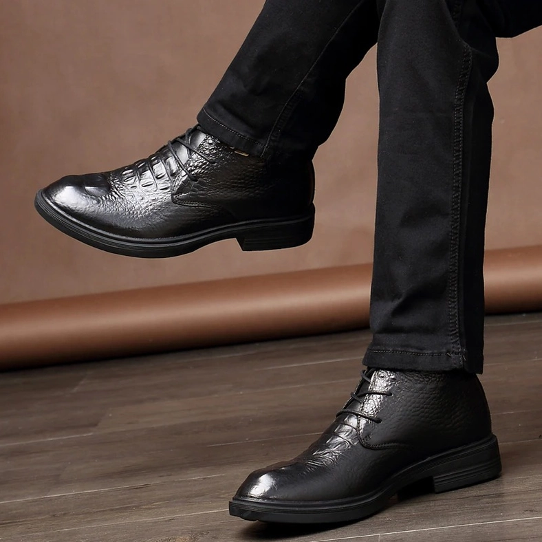 Black gothic boot with crocodile grain leather texture and metal lace fasteners, angled side view