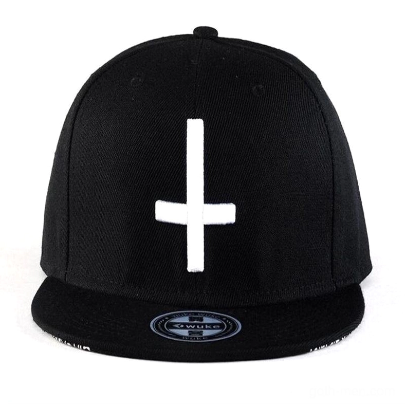 Direct front view black gothic snapback cap with prominent white cross embroidery and flat bill design