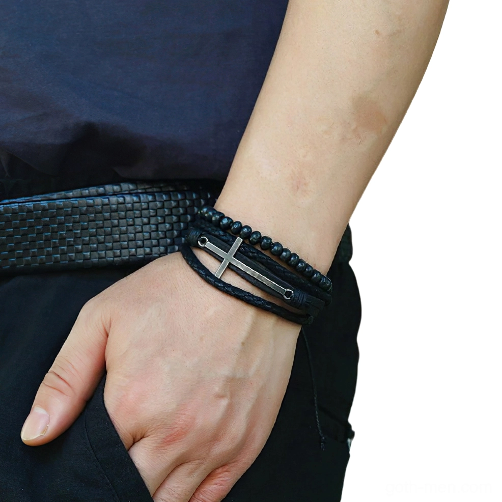 Adjustable gothic cross leather bracelet worn on male wrist - side view showing fit and styling