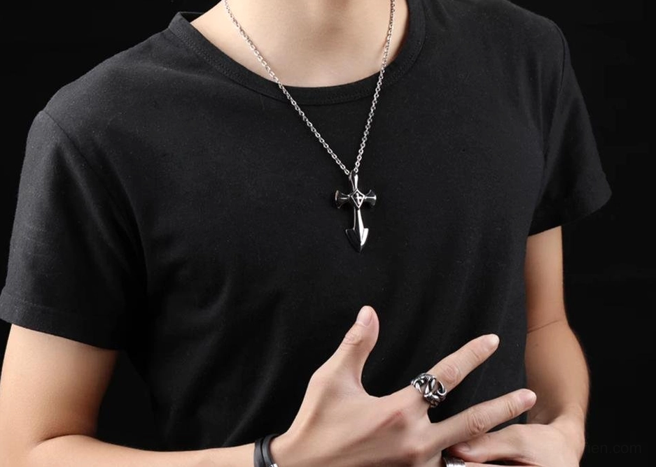 Unisex stainless steel cross pendant necklace worn on male model with black casual t-shirt