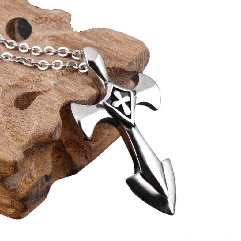 Side profile of stainless steel cross pendant with anchor tail design on wooden background