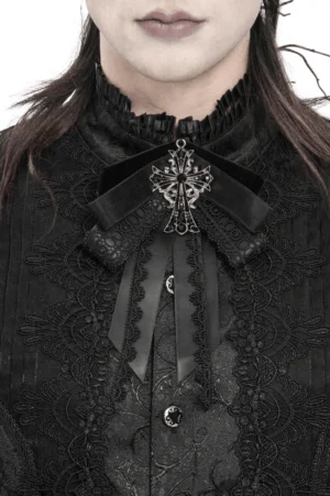 Black gothic cross ribbon brooch with silver ornament and lace trim on male model, front neck close-up view